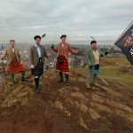 Rallying the Clans together.  Chiefs of Clans Bruce, Leslie, Macnab and Carmichael on Salisbury Crags with Edinburgh Castle below.